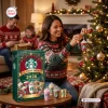 Woman hanging an ornament from the Starbucks Holiday & Iconic Drinks Advent Calendar 2026 on a tree.