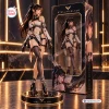 Front view of a Stellar Blade vinyl figure standing on a black and gold base next to its packaging box.
