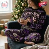 Woman wearing a Stevie Nicks Christmas Celestial Sweater and Jogger Set sitting by a tree.