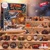 Front view of Stihl 100th Anniversary 1926-2026 Advent Calendar box alongside twenty-four mini acrylic ornaments displayed on wooden steps.