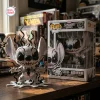 Front view of Stitch Anti-Venom Symbiote Vinyl Figure outside its box on a wooden desk.