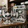 Front view of Stitch Anti-Venom Symbiote Vinyl Figure next to its box on a wooden bookshelf.