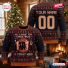 Front and back view of a dark blue custom Christmas ugly sweater with band photos and text.