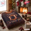 Folded Stray Kids Christmas Custom Name Ugly Sweater on a wooden table with pinecones and hot cocoa.