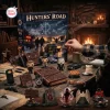 Closeup of a person opening the Supernatural Hunters Road Advent Calendar 2026 box with figurines and journals.