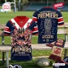 Front and back views of Sydney Roosters 2026 NRL Premiership Shirt displayed on a wooden bench.