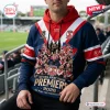 Front view of Sydney Roosters 2026 Premiers rugby hoodie with team graphics and red and white stripes.