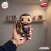 Hand holding a Sydney Roosters James Tedesco 2026 vinyl figure holding a trophy.