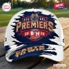 Front view of Sydney Roosters NRL Premiers 2026 cap featuring red, white, and blue graphics on a wooden table.