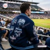Rear view of a person wearing a navy blue Tampa Bay Rays 2026 World Series Baseball Jacket while seated in a stadium.