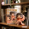 Front view of Tay 100 Weeks Billboard 200 Vinyl Figure next to its packaging on a wooden bookshelf.