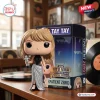 Front view of Taylor Swift 2026 MTV VMA vinyl figure holding a silver award next to its box.