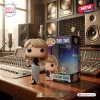 Front view of the Taylor Swift 2026 MTV VMA Vinyl Figure next to its packaging in a studio.