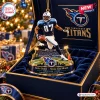 Close-up view of the Tennessee Titans Music City Miracle Christmas Ornament featuring a running player figurine in a lit box.
