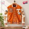 Front view of an orange and white Tennessee Volunteers varsity baseball jacket with chenille patches hanging on a wooden hanger.