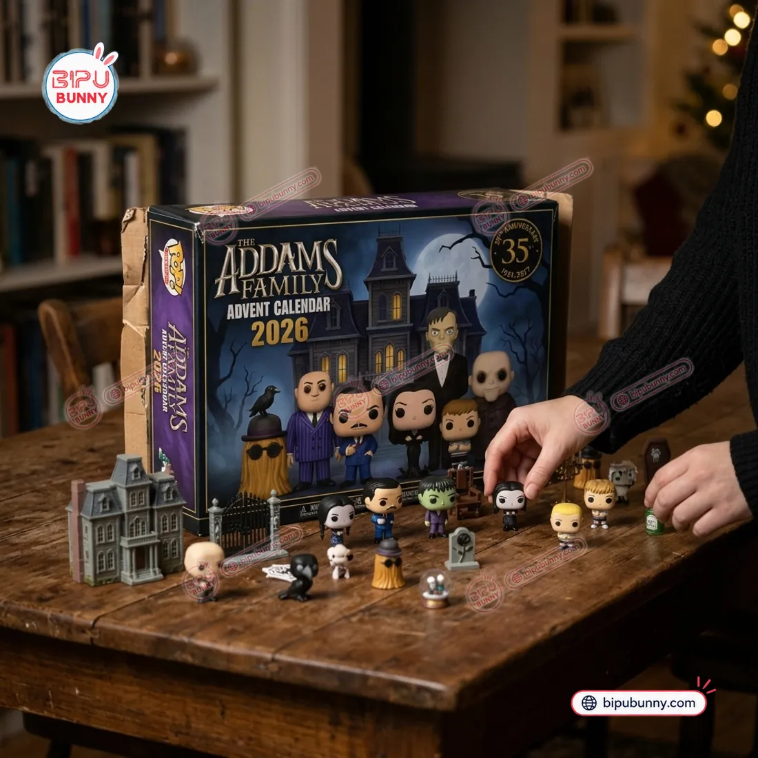 Hands arranging Wednesday, Pugsley, Lurch, Gomez, Cousin Itt, and gothic mansion props in front of The Addams Family 2026 Advent Calendar box