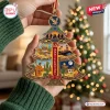 Close-up of The Eagles 55th Anniversary Christmas Ornament held in hands against a tree background.