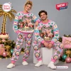 Front view of a man and woman wearing matching pink and blue patterned The Golden Girls Stay Golden Sweater and Jogger Set.