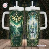 Front and back view of The Legend of Zelda 40th Anniversary Tumbler featuring green forest and castle artwork with a handle.