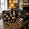 Front view of The Mummy 1999 Hamunaptra Advent Calendar with open numbered compartments and tiny figures displayed on a wooden table.