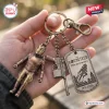 Closeup of The Rocketeer 35th Anniversary Keychain held in a hand, featuring multiple charms.