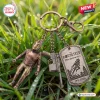 Closeup of The Rocketeer 35th Anniversary Keychain resting on dewy green grass.