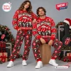Front view of two models wearing matching red Rolling Stones Christmas sweaters and plaid pants.