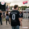 Back view of a person wearing The Smashing Pumpkins Rats In A Cage Tour Black Baseball Jersey at an outdoor concert.