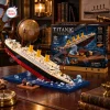 Completed Titanic Sinking Ship Model Building Block Set displayed beside its product box on a wooden desk.