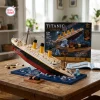 Completed Titanic Sinking Ship Model Building Block Set displayed on a wooden table with its packaging box.