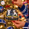 Hands holding a Toronto Blue Jays Joe Carter Christmas Ornament on a tree.