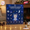 Front view of a blue UEFA Champions League 2026 Advent Calendar with numbered doors and soccer motifs on a wooden table.