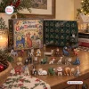 Front view of Ugly Medieval Cats Advent Calendar with open box and twenty-four figurines displayed on a table.