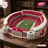 Angled view of University of Alabama Plush Stadium Pillow on wooden table.