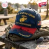 Front view of a US Marine Corps 250th Anniversary Baseball Cap resting on a backpack outdoors.