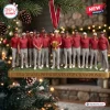 Front view of a USA Team Presidents Cup Champions Christmas Ornament featuring a group of golfers holding a trophy.