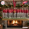 Front view of the USA Team Presidents Cup Champions Christmas Ornament hanging in front of a fireplace.