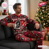 Man wearing Van Halen Christmas Sweater And Pants Set while holding a mug on a sofa near a tree.
