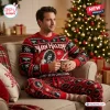 Man wearing a Van Halen Christmas sweater and pants set while holding a mug on a couch.