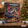 Front view of a Warhammer 40000 40th Anniversary 1987-2027 Advent Calendar box on a wooden surface with small figurines.