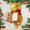 Hanging Winnie the Pooh Bookish and Bright Christmas Ornament on tree branch.