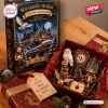 Front view of Wizarding World 2026 Advent Calendar box alongside an open red box displaying ornaments.