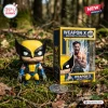 Front view of the Wolverine Weapon X Vinyl Figure standing on a mossy forest floor beside its box.