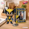 Front view of Wolverine Weapon X vinyl figure next to its box with claws extended on a wooden desk.