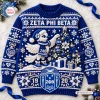 Front view of a Zeta Phi Beta blue cable knit Christmas sweater featuring a white bird, decorated tree, and snowflakes.