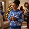Front view of a Zeta Phi Beta blue cable knit Christmas sweater worn at a holiday gathering.